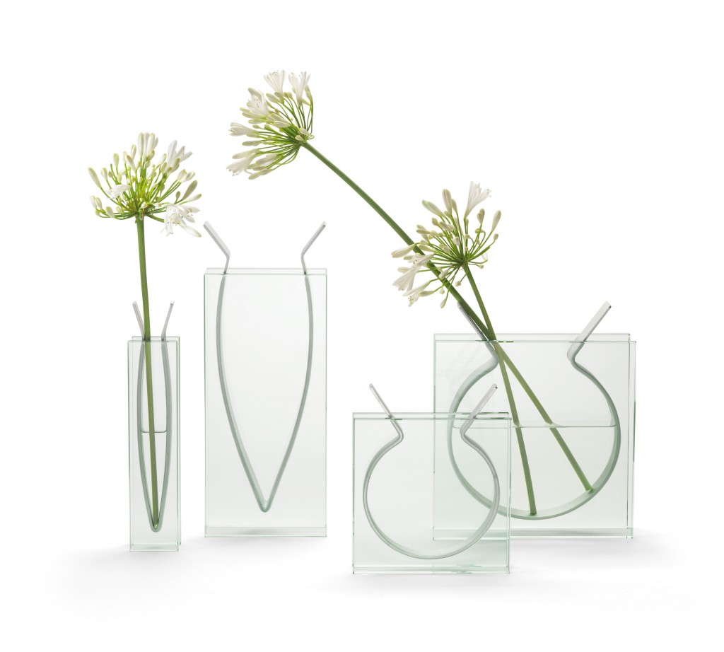 A metal band, curved to hold water and flowers, is suspended securely between parallel walls of glass in this vase, available at the High Museum gift shop. 